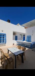a patio with a table and chairs in a room at Dar Aziz in Sousse
