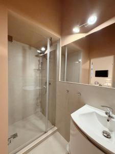 a bathroom with a shower and a sink at Center feelings studio by Alandala in Cluj-Napoca