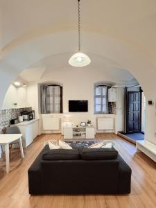 a living room with a black couch and a table at Center feelings studio by Alandala in Cluj-Napoca