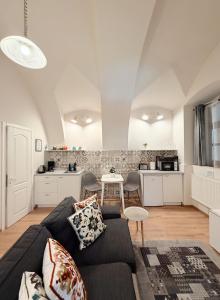 a living room with a couch and a kitchen at Center feelings studio by Alandala in Cluj-Napoca