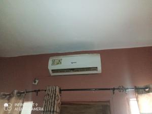 a air conditioner on the ceiling of a room at Hôtel Maximum in Agbézourhlan