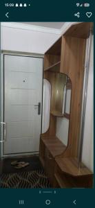 a small room with a door and a mirror at 2-kichik daha in Andizhan