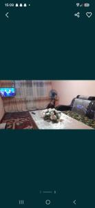 a picture of a bedroom with a bed and a television at 2-kichik daha in Andizhan