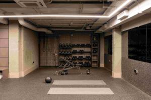an empty room with a gym with equipment in it at Locke at Broken Wharf in London
