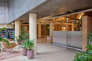 a lobby with potted plants in a building at Locke at Broken Wharf in London
