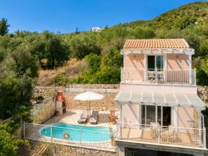 a villa with a swimming pool and a house at Villa Magda Dione in Gaios