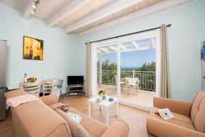 a living room with a couch and a table at Villa Magda Dione in Gaios