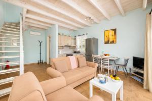 a living room with a couch and a table at Villa Magda Dione in Gaios