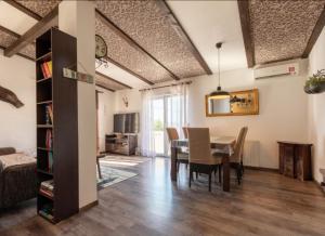 a living room with a table and a dining room at Home sweet home- Rab in Barbat na Rabu