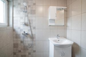 a bathroom with a shower and a sink at Central Summer Theatre Suites in Veliko Tŭrnovo +149 photos
