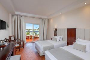 a hotel room with two beds and a balcony at Royal Brayka Beach Resort in Marsa Alam City +61 photos