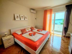a bedroom with a bed and a large window at Room`s Brica in Barbat na Rabu