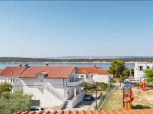 a view of a house with a playground at Home sweet home- Rab in Barbat na Rabu