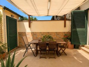a wooden table and chairs on a patio at Casa Camelia Mare in Viareggio