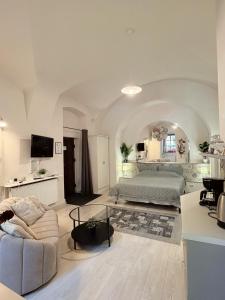 a large bedroom with a bed and a couch at Alandala Story in Cluj-Napoca