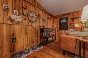 a living room with wooden walls and a couch at Re-Up Retreat King Bed, Hot Tub, Zero Pet Fees in Whittier