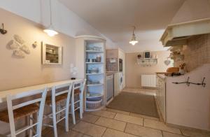 a kitchen with white cabinets and a counter top at Home sweet home- Rab in Barbat na Rabu