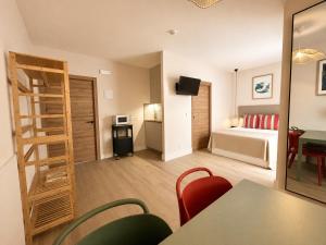 a room with a room with a bed and a ladder at 10ToSea Premium Hostal in Fuengirola