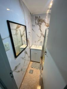 a bathroom with a sink and a mirror at Candil in Neuquén