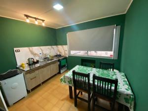 a kitchen with a table and chairs in a room at Candil in Neuquén