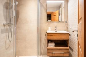 a bathroom with a shower and a sink at Landhotel Vordergrub in Kitzbühel