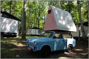 a blue car with a tent on top of it at KULT TRABANT "Villa Sachsenruh" direkt am Strand in Dranske +42 photos