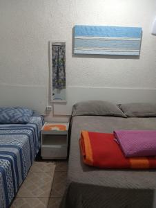 a room with two beds and a mirror on the wall at Hostel Brasil Gru in Guarulhos