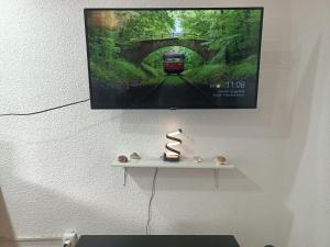 a picture of a train on a wall with a shelf at Apartamento Libertad in Elda