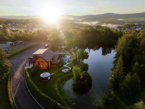 an aerial view of a house next to a lake at Le Versant Mont-Sainte-Anne in Saint-Férréol-les-Neiges