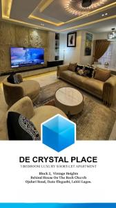 a large living room with couches and a tv at De Crystal Place in Ikate