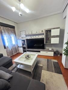 a living room with a couch and a coffee table at Centrico tu hogar en Bilbao in Barakaldo
