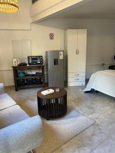 a living room with a coffee table and a refrigerator at Rubí Department in Santa Rosa