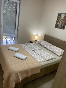 a bedroom with a bed with two towels on it at DREAM house in Paraćin