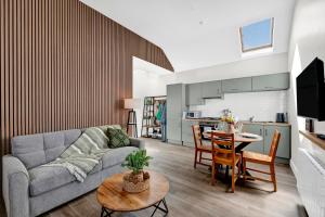a living room with a couch and a table at Millmaster Apartment in Drumahayre