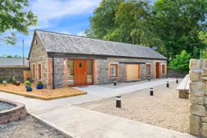 a stone house with a courtyard in front of it at Millmaster Apartment in Drumahayre