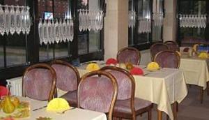 a dining room with tables and chairs and chandeliers at Zur Alten Brauerei in Jessen