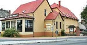a building with a red roof on the side of a street at Zur Alten Brauerei in Jessen