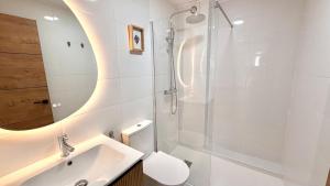 a bathroom with a toilet and a sink and a shower at 10ToSea Premium Hostal in Fuengirola +31 photos