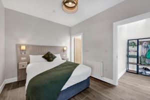 a bedroom with a large bed in a room at Millmaster Apartment in Drumahayre