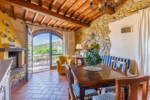 a kitchen and dining room with a wooden table and chairs at La Vecchia Sassa in Montaione