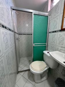 a bathroom with a toilet and a shower and a sink at Hotel Imperio Real Medellin in Medellín