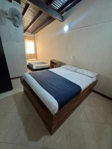 a bedroom with a large bed in a room at Hotel Imperio Real Medellin in Medellín