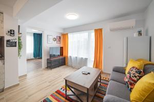 a living room with a couch and a table at Central Summer Theatre Suites in Veliko Tŭrnovo