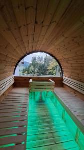 a swimming pool with benches in a wooden structure at Erlebnisbauernhof Gutschi Ranch in Kamp