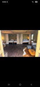 a living room with two beds and a couch at The Mid Devon Retreat in Crediton +18 photos