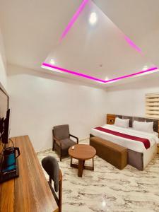 a bedroom with a bed and a couch and a table at Lexworld Hotels in Aba +49 photos