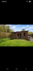a small house in a field of grass at The Mid Devon Retreat in Crediton