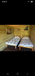 two beds in a room with a wall at The Mid Devon Retreat in Crediton