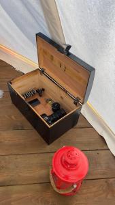 a wooden tool box sitting on the floor next to a red fire hydrant at glamping podtrosky in Troskovice +29 photos