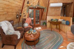 a living room with chairs and a table in a cabin at Halfling House w/hot tub/firepit/more! in Coarsegold